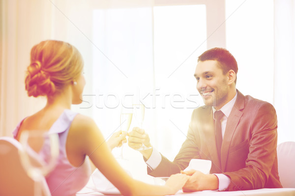 couple with glasses of champagne at restaurant Stock photo © dolgachov