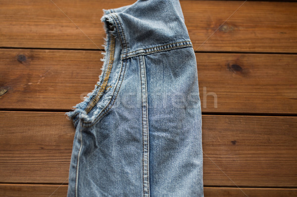 close up of denim vest or waistcoat on wood Stock photo © dolgachov