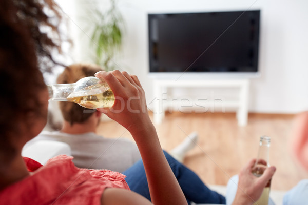 woman drinking beer and watching tv at home Stock photo © dolgachov