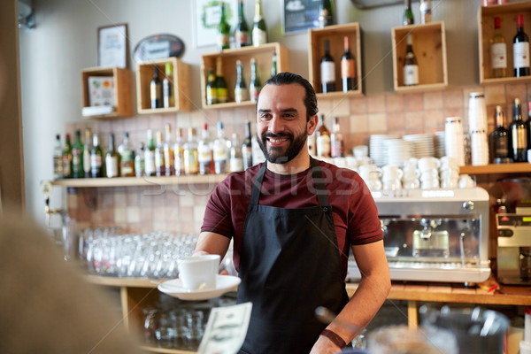 man or waiter serving customer at coffee shop Stock photo © dolgachov