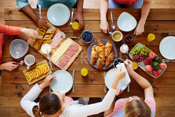 group of people having breakfast at table Stock photo © dolgachov