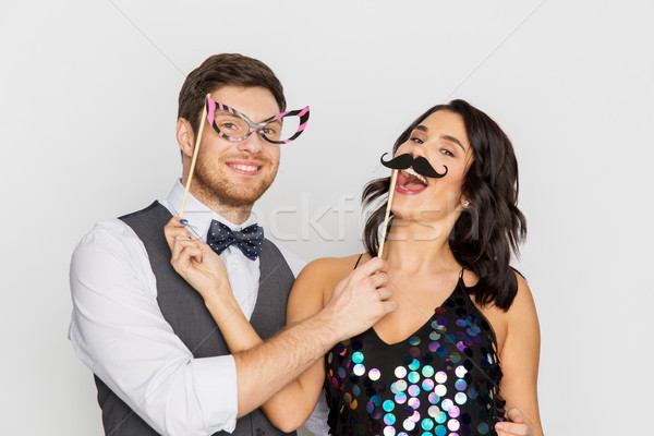 happy couple with party props having fun Stock photo © dolgachov