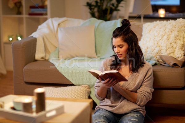 happy young woman reading book at home Stock photo © dolgachov