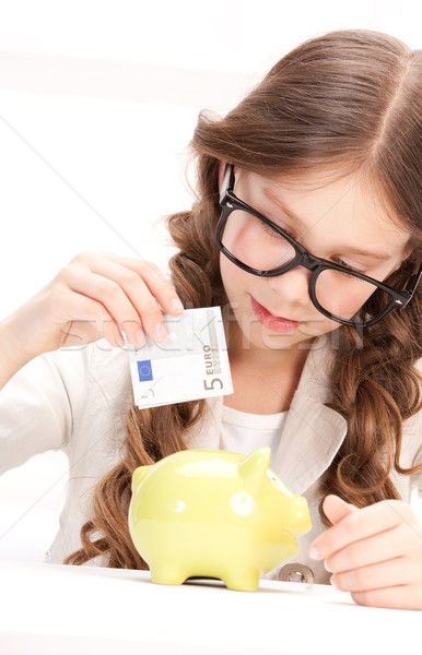 little girl with piggy bank and money Stock photo © dolgachov
