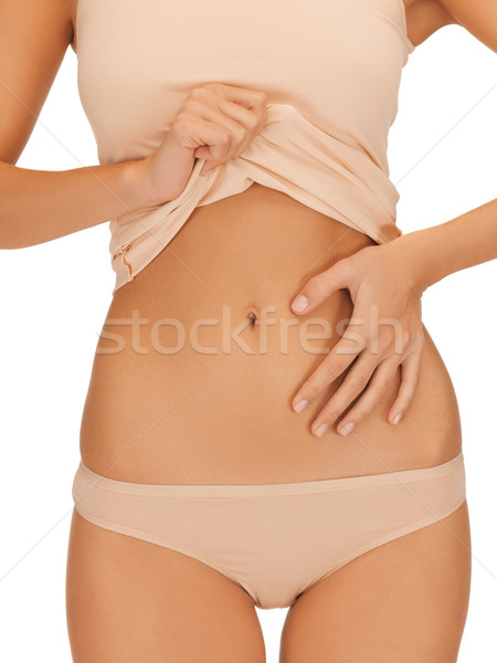 woman placing hand on her belly Stock photo © dolgachov