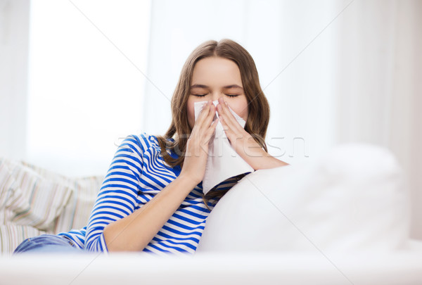 sick teenage girl with paper tissue Stock photo © dolgachov