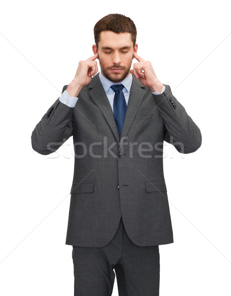 annoyed businessman covering ears with his hands Stock photo © dolgachov