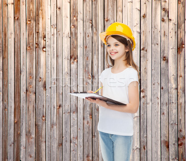 smiling little girl in hardhat with clipboard Stock photo © dolgachov
