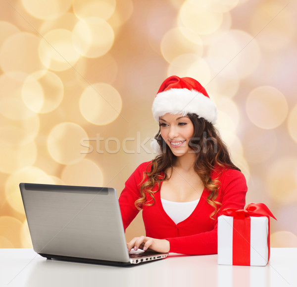 smiling woman with gift box and laptop Stock photo © dolgachov