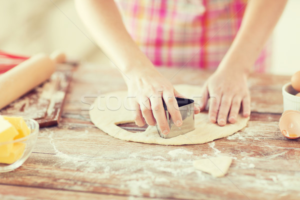 close up of hands making cookies from fresh dough Stock photo © dolgachov