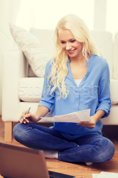 smiling woman with papers, laptop and calculator Stock photo © dolgachov