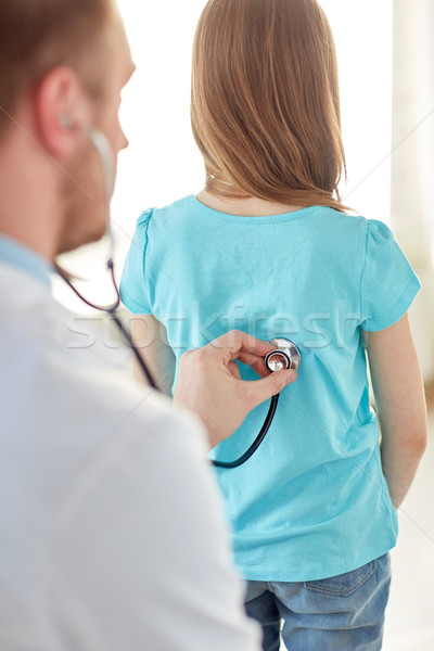 close up of girl and doctor on medical exam Stock photo © dolgachov