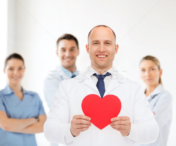 smiling male doctor with red heart Stock photo © dolgachov
