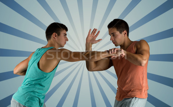 young men fighting hand-to-hand Stock photo © dolgachov