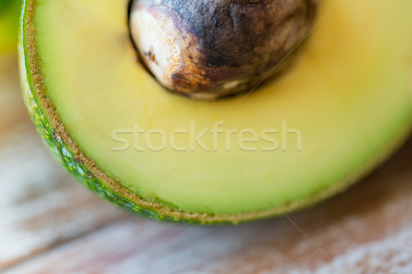 close up of ripe avocado with bone on table Stock photo © dolgachov