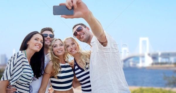 friends taking selfie with smartphone Stock photo © dolgachov