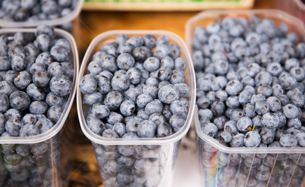 close up of blueberries in boxes at street market Stock photo © dolgachov