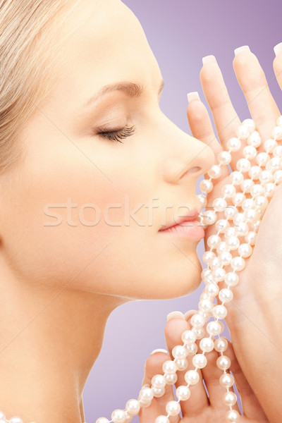 beautiful woman with sea pearls beads over violet Stock photo © dolgachov