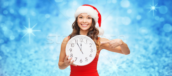 woman in santa helper hat with clock showing 12 Stock photo © dolgachov