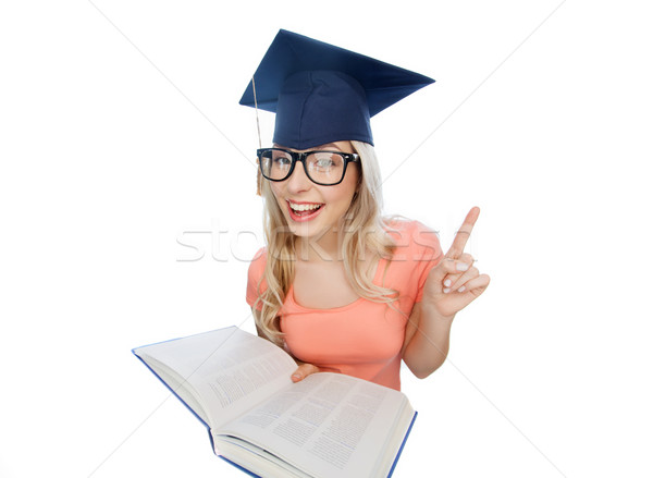 student woman in mortarboard with encyclopedia Stock photo © dolgachov