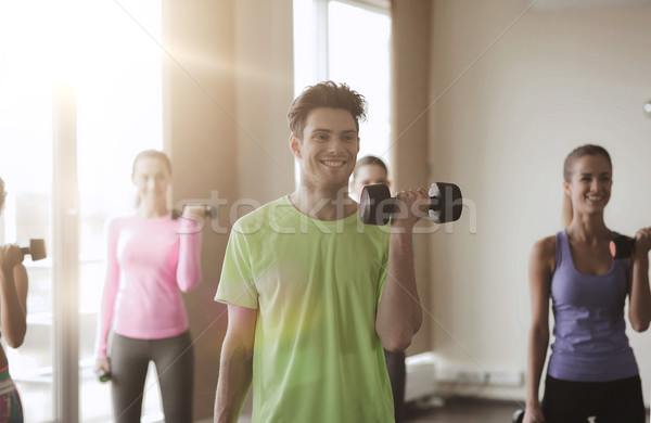 group of smiling people working out with dumbbells Stock photo © dolgachov