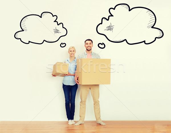 couple with cardboard boxes moving to new home Stock photo © dolgachov
