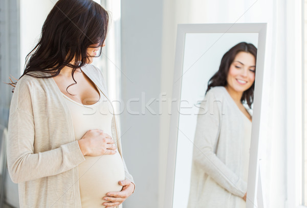 Сток-фото: беременная · женщина · глядя · зеркало · беременности · материнство