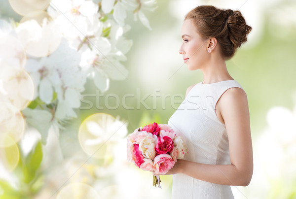 Stock photo: bride or woman in white dress with flower bunch