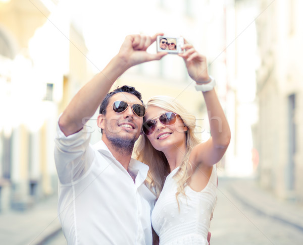 travelling couple taking photo picture with camera Stock photo © dolgachov