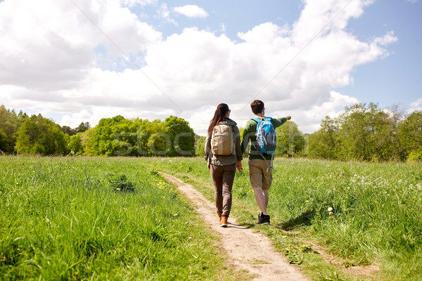 Stock photo: happy couple with backpacks hiking outdoors