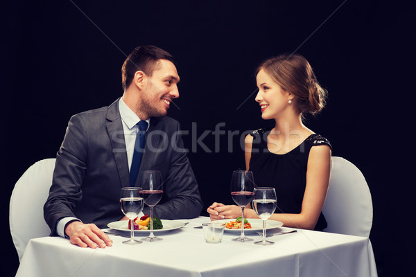 Stock photo: smiling couple eating main course at restaurant