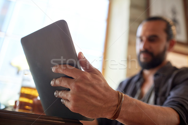 close up of man with tablet pc and beer at pub Stock photo © dolgachov