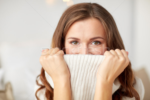 young woman or teen girl pulling pullover collar Stock photo © dolgachov