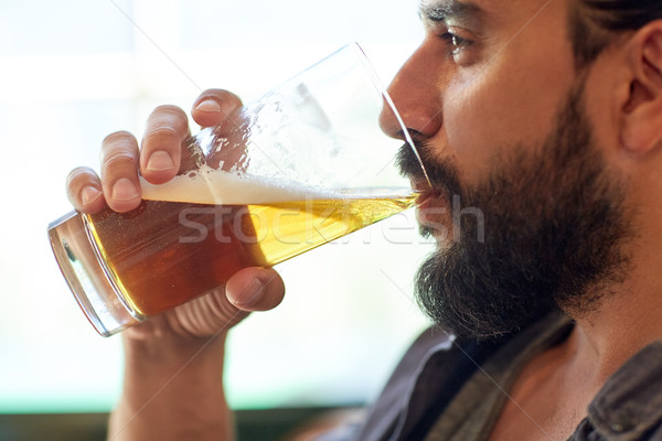 close up of man drinking beer at bar or pub Stock photo © dolgachov