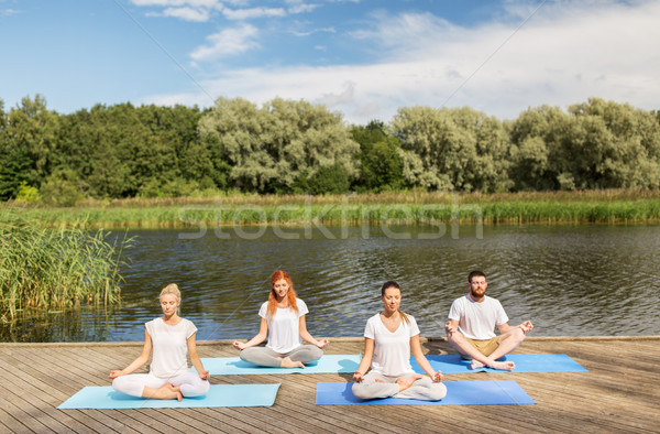 Emberek meditál jóga lótusz póz kint Stock fotó © dolgachov