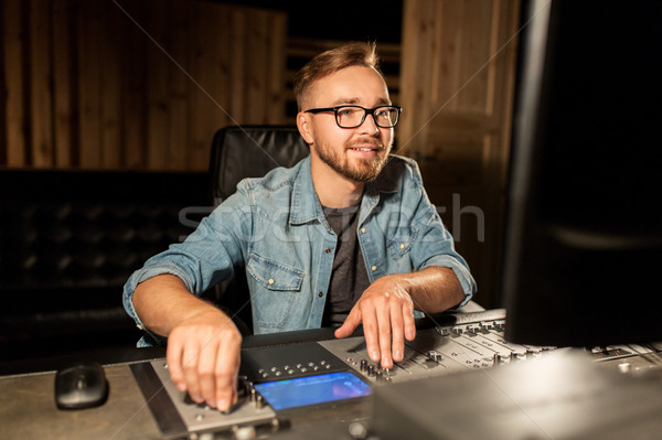 man at mixing console in music recording studio Stock photo © dolgachov