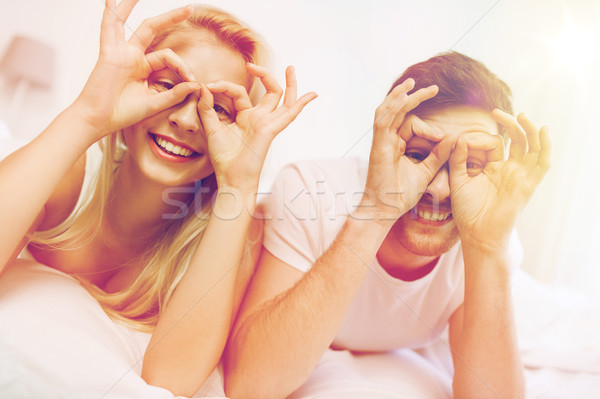 happy couple lying in bed at home Stock photo © dolgachov