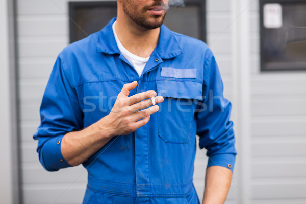 close up of auto mechanic smoking cigarette Stock photo © dolgachov