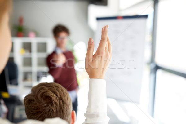 woman raising hand at presentation in office Stock photo © dolgachov