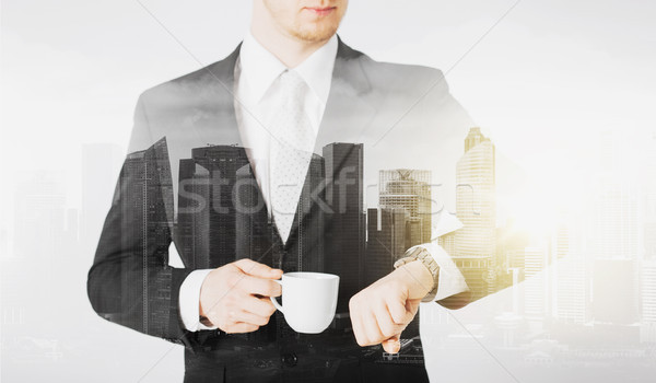 close up of businessman with wristwatch and coffee Stock photo © dolgachov