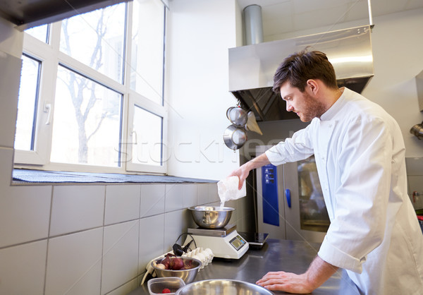 happy male chef cooking food at restaurant kitchen Stock photo © dolgachov