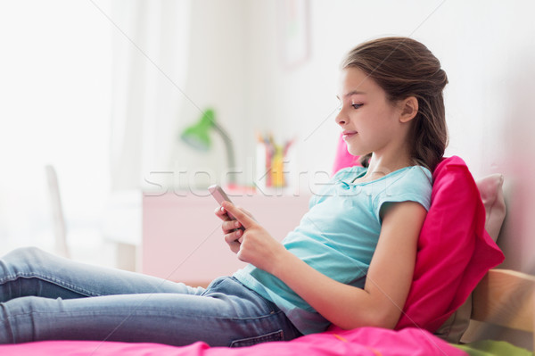 Mosolyog lány sms chat okostelefon otthon gyerekek Stock fotó © dolgachov