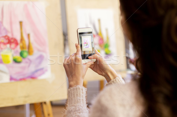 woman with painting on smartphone at art school Stock photo © dolgachov