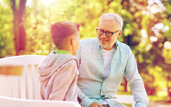 grandfather and grandson talking at summer park Stock photo © dolgachov
