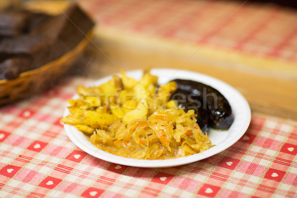 braised cabbage and sausages with sauce on plate Stock photo © dolgachov