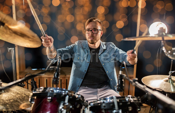 musician or drummer playing drum kit at concert Stock photo © dolgachov