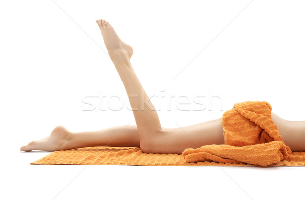 long legs of relaxed lady with orange towel #2 Stock photo © dolgachov