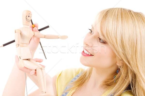 happy teenage girl with wooden model dummy Stock photo © dolgachov