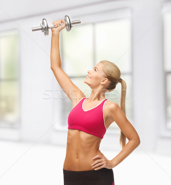 woman lifting steel dumbbell Stock photo © dolgachov