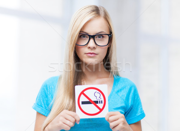 woman with smoking restriction sign Stock photo © dolgachov